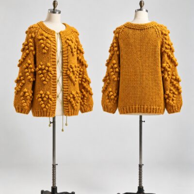 Front and back of a mustard cardigan with raised bobble motifs, long sleeves, ribbed cuffs and a plain knit back