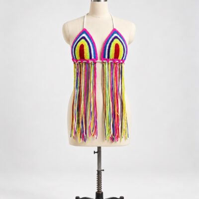 Front view of a rainbow triangle crochet halter top with pink borders, white neck straps and long multicolor fringe